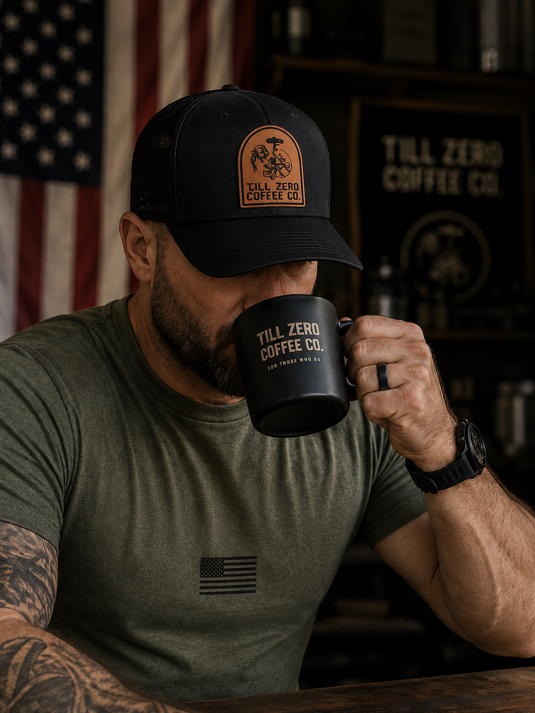 Till Zero Coffee Co. tee in olive worn with the TZCO trucker cap, drinking from a Till Zero mug
