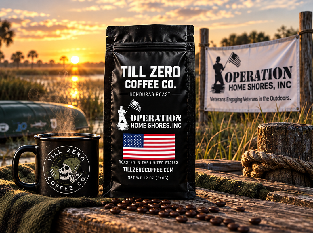 A bag of Till Zero Coffee Co. Operation Home Shores Honduras Roast and a steaming Till Zero mug on a weathered dock at sunset, beside a canoe and an Operation Home Shores, Inc. banner reading Veterans Engaging Veterans in the Outdoors